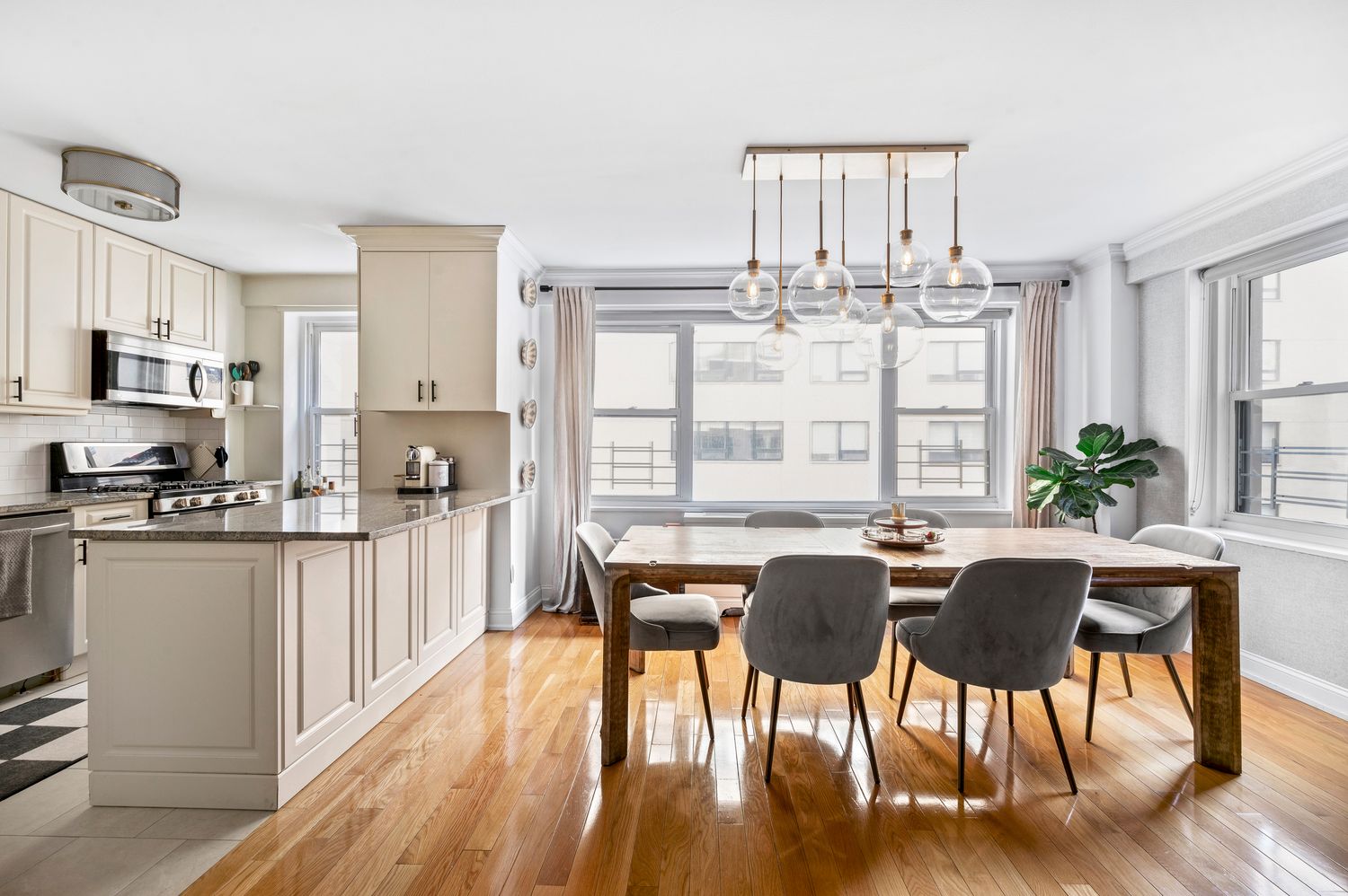 a view of a dining room with furniture window and wooden floor