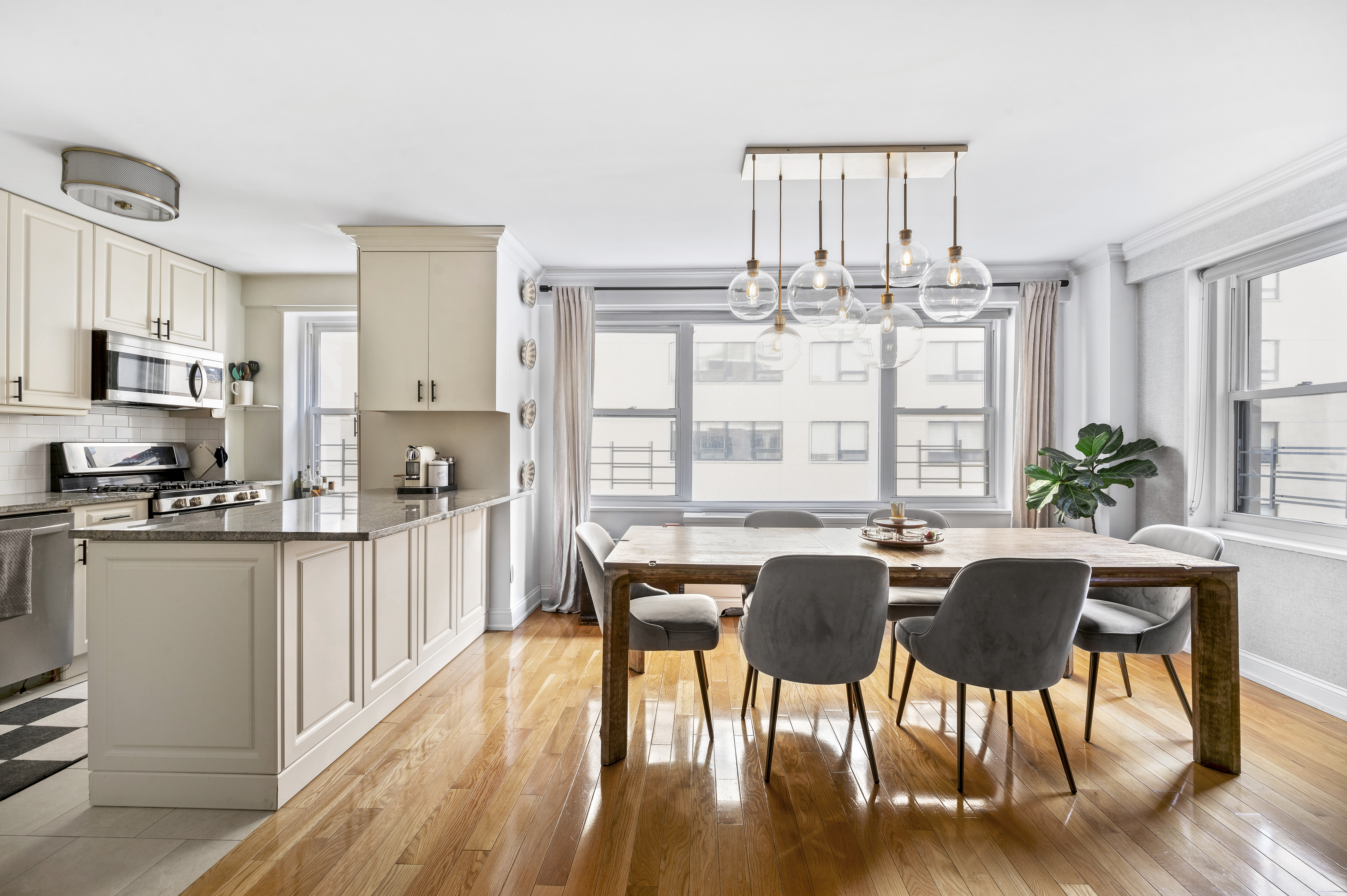 201 East 79th Street, Unit 6A Manhattan, NY 10075 - Photo 1 of 11 a view of a dining room with furniture window and wooden floor