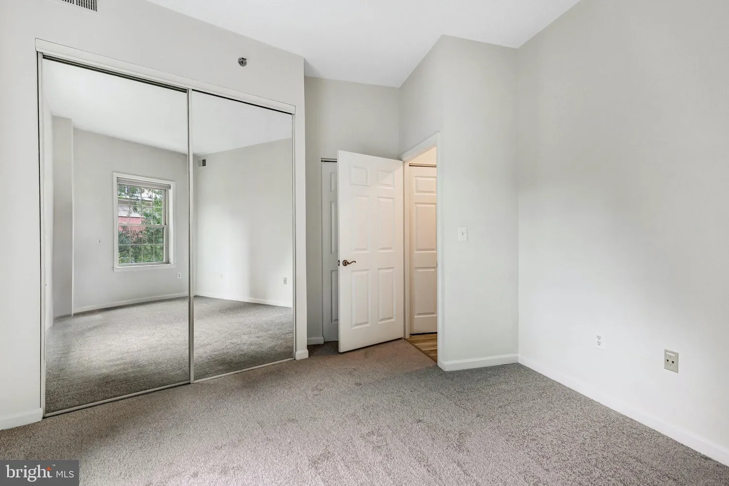 a view of an empty room with closet