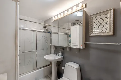 a bathroom with a sink toilet and shower
