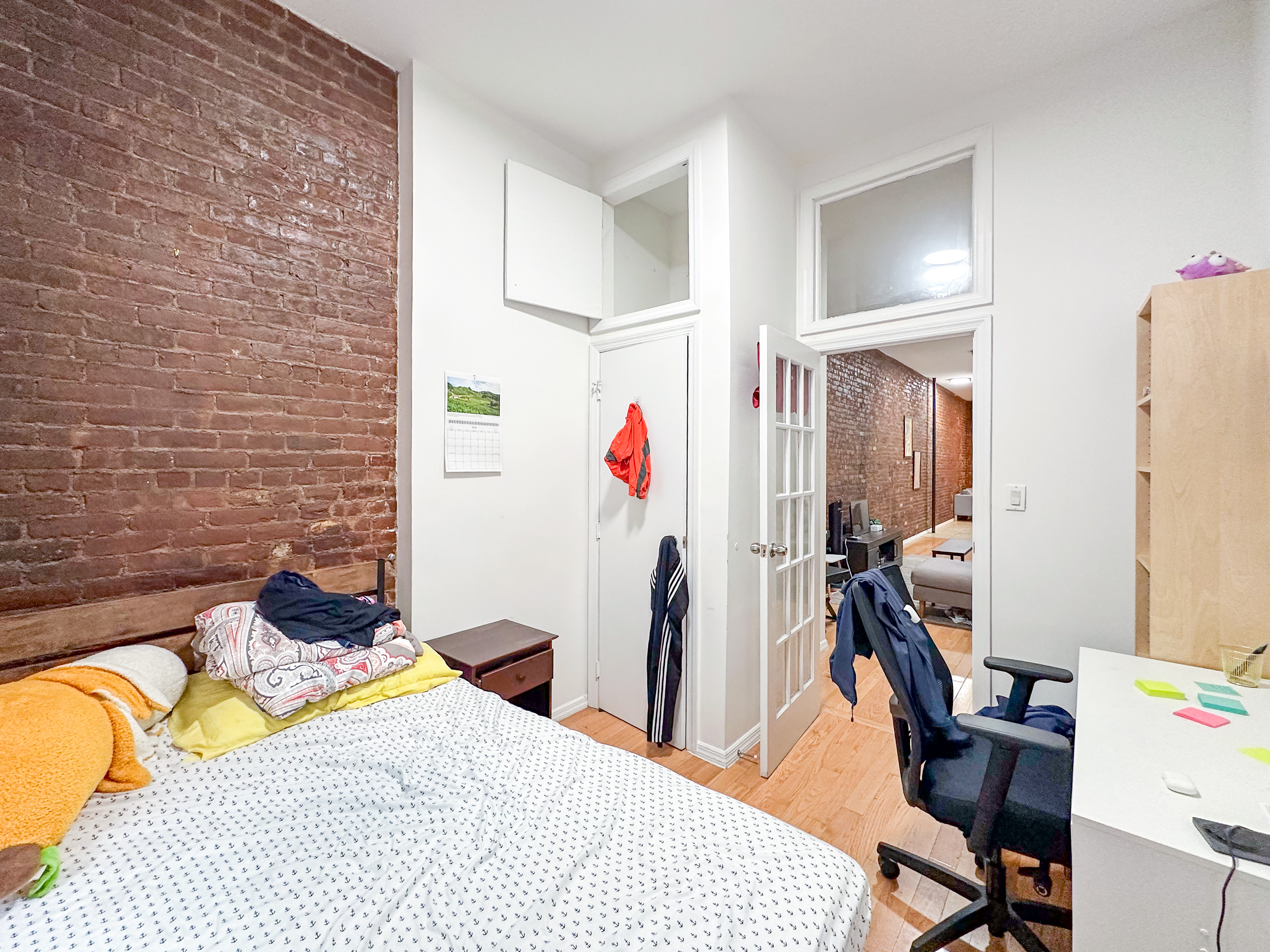 213 East 5th Street, Unit 1 Manhattan, NY 10003 - Photo 4 of 18 a bedroom with a bed and a desk