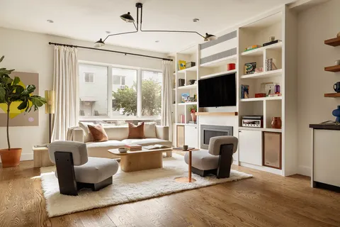 a living room with furniture fireplace and flat screen tv