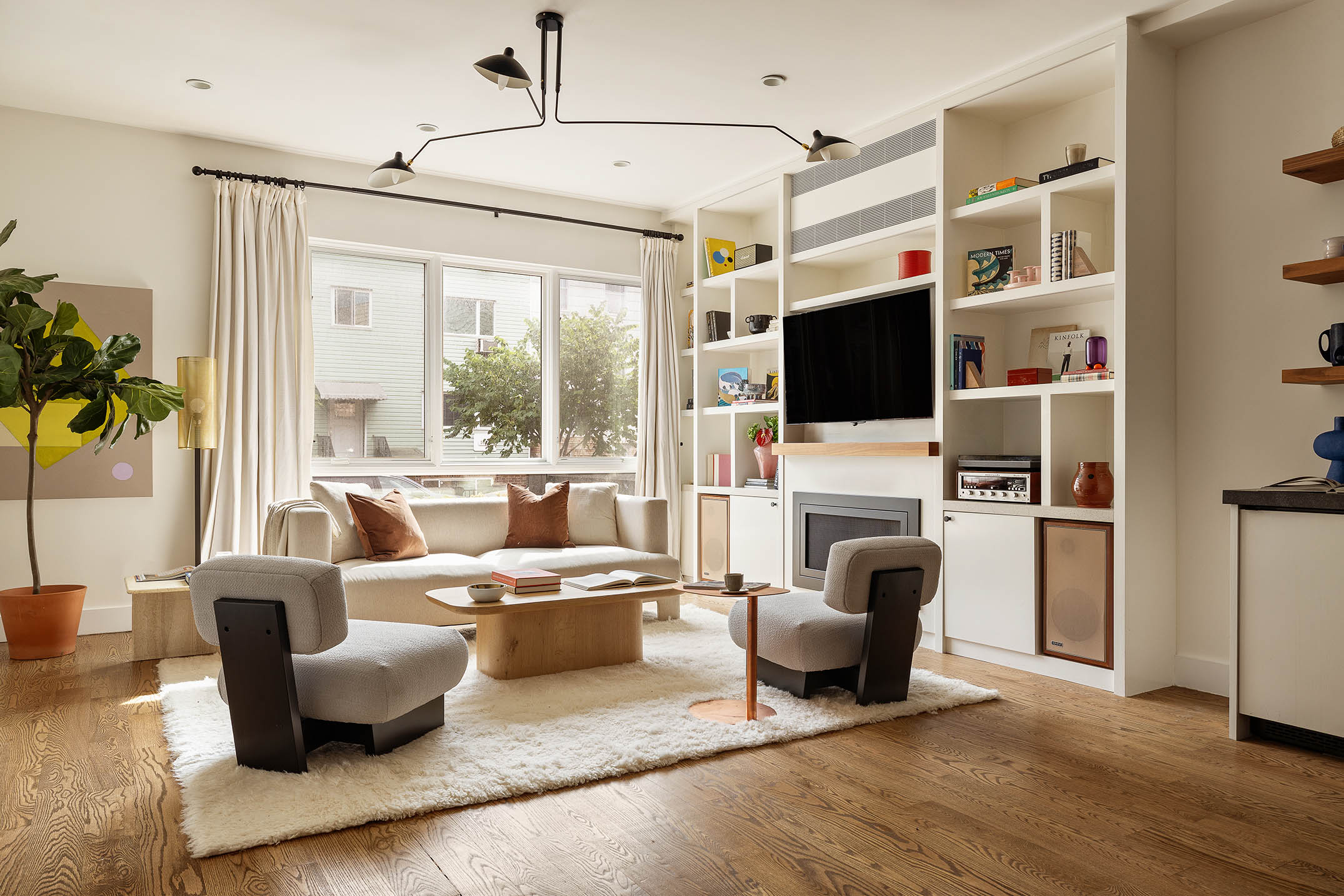 a living room with furniture fireplace and flat screen tv