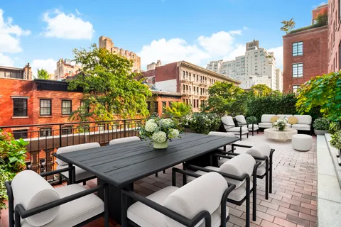 a view of a patio with table and chairs and potted plants