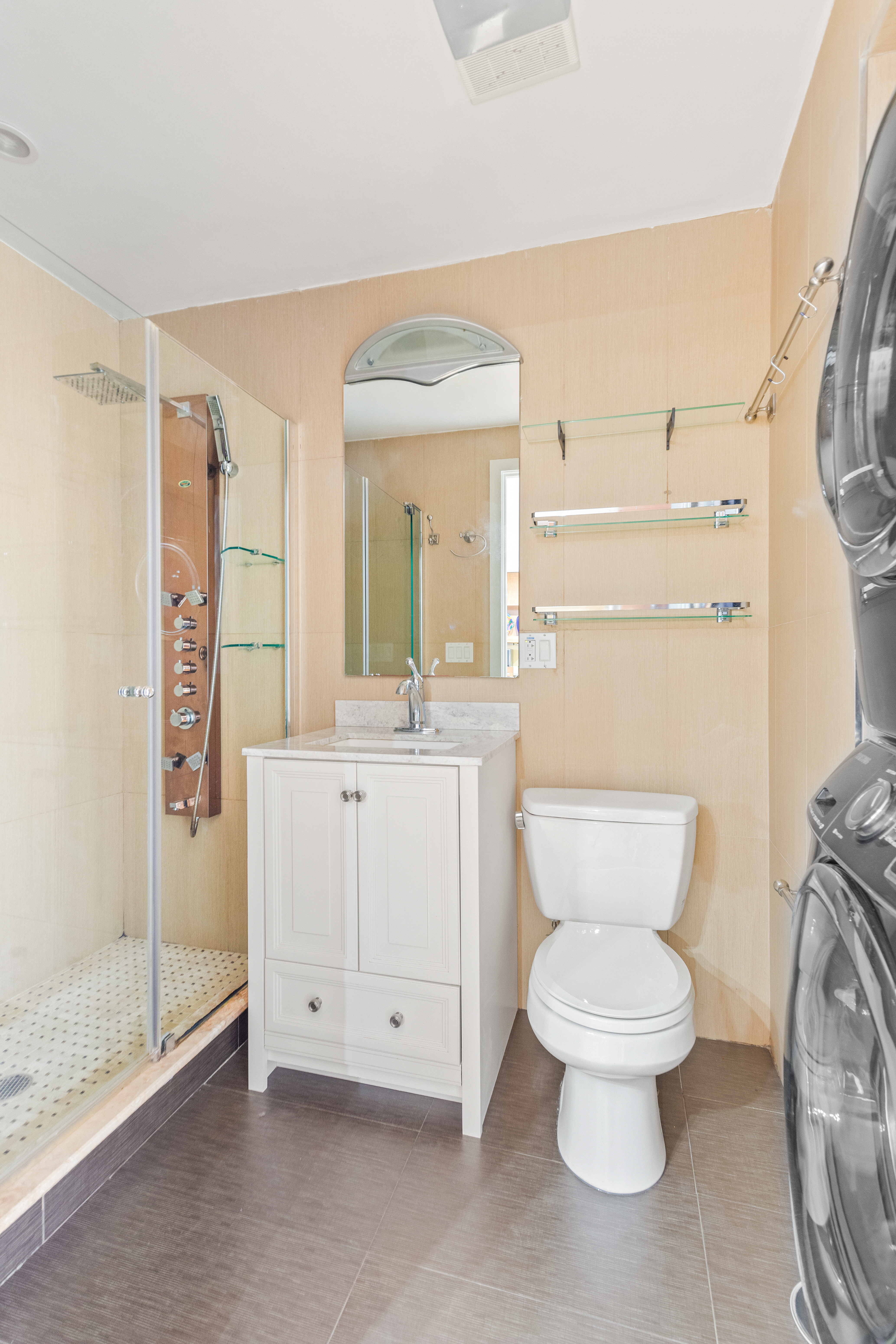 62 Brighton 2nd Place, Unit 4B Brooklyn, NY 11235 - Photo 8 of 12 a bathroom with a toilet sink and a mirror