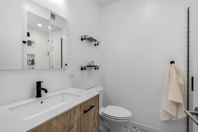 161 Remsen Street, Unit 2C Brooklyn, NY 11242 - Photo 6 of 13 a bathroom with a sink a toilet and shower
