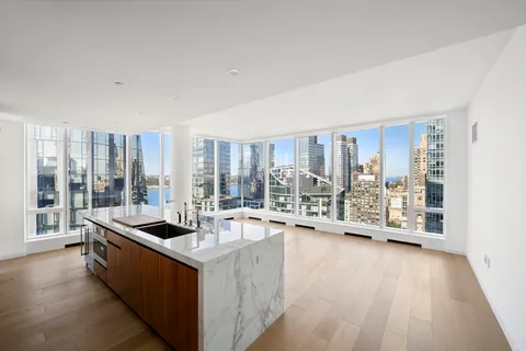 a large white room with a large window and furniture