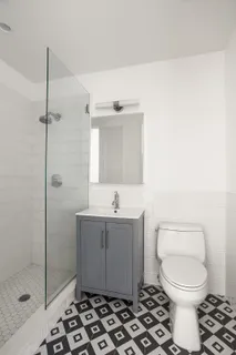 a bathroom with a toilet a sink and shower