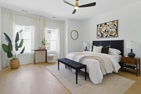 a bedroom with a bed a couch and a window