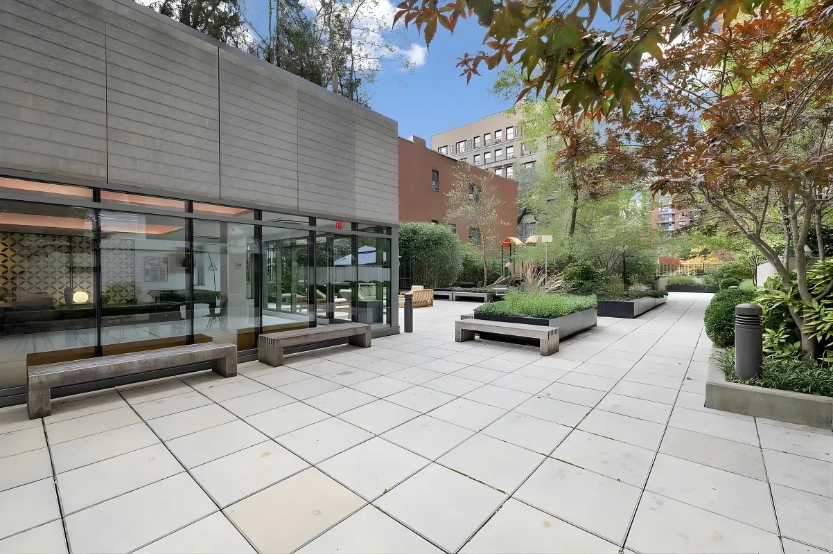 a view of a patio with table and chairs and potted plants