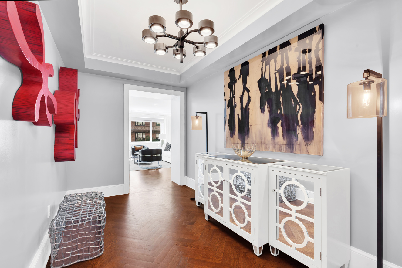 530 Park Avenue, Unit 4A Manhattan, NY 10065 - Photo 9 of 16 a view of a hallway with wooden floor and staircase