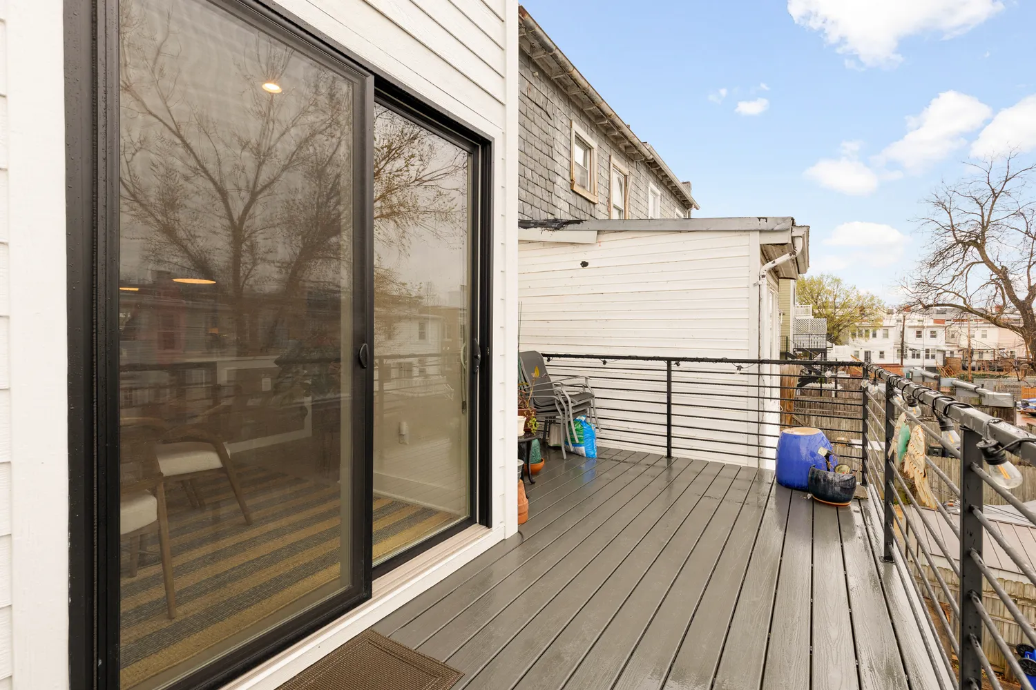 a view of a balcony with wooden floor and iron stairs