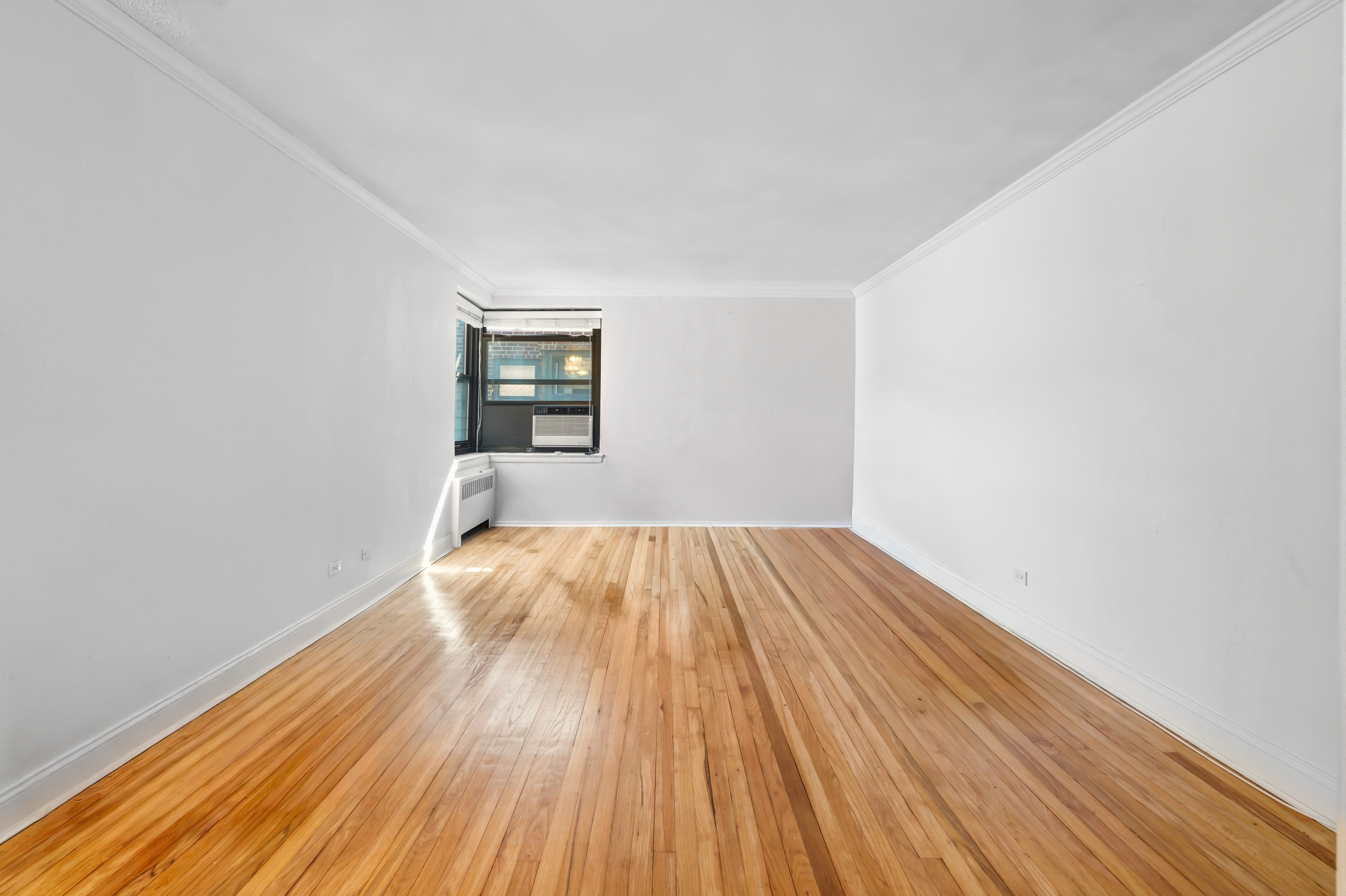 32-40 91st Street, Unit 510 Queens, NY 11369 - Photo 5 of 5 wooden floor in a empty room