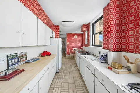 a kitchen with a sink stove and cabinets