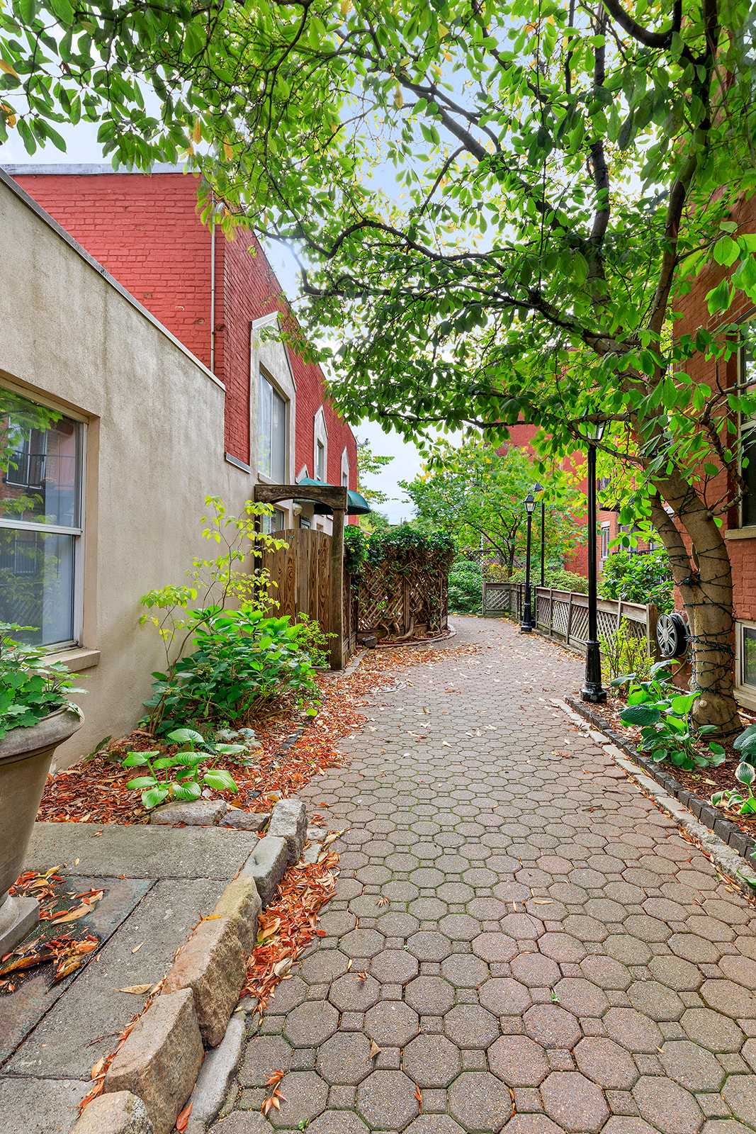 61-20 71st Avenue, Unit J1B Queens, NY 11385 - Photo 12 of 13 a view of a yard with plants and a bench