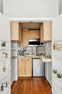 a kitchen with a sink cabinets and window
