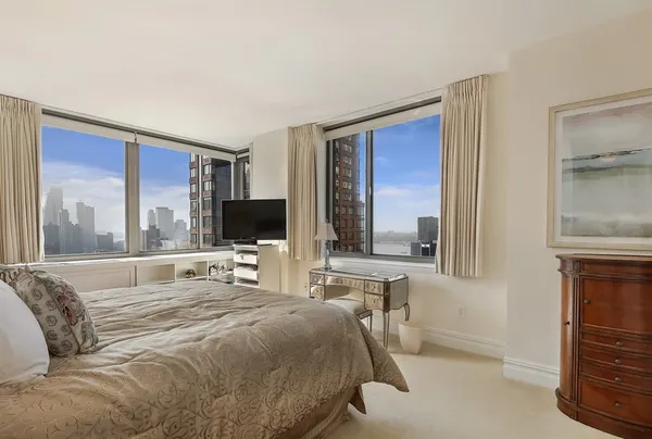 a bedroom with a bed and a flat screen tv