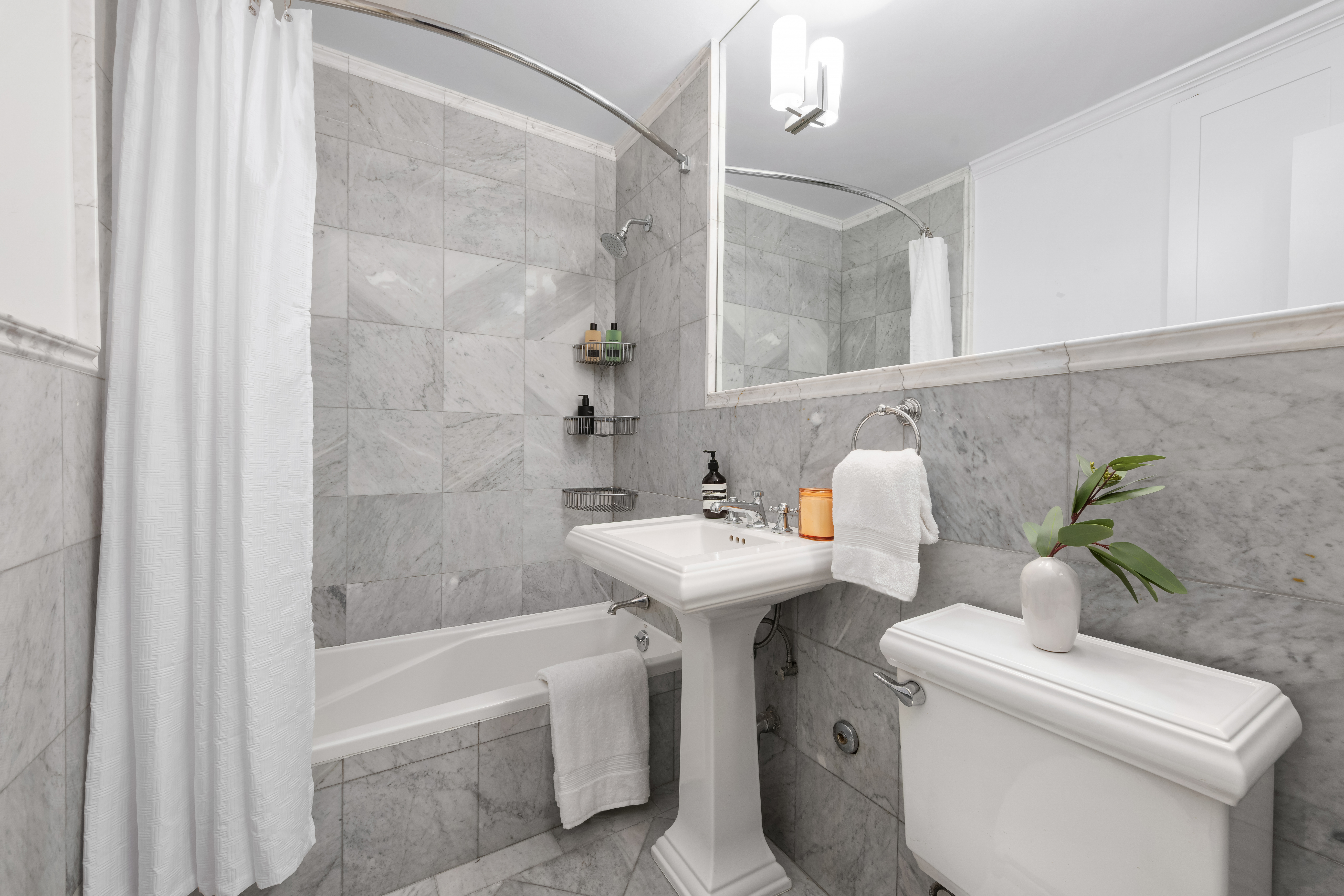 2 Charlton Street, Unit 7J Manhattan, NY 10014 - Photo 9 of 15 a bathroom with a sink a toilet and shower