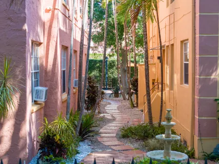 a bedroom with a large bed and a potted plant