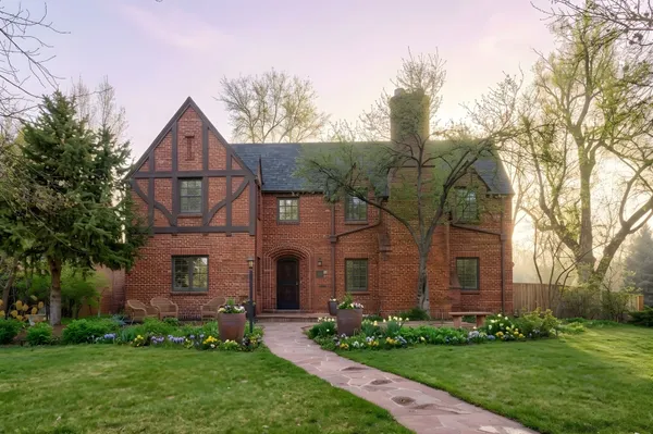a front view of a house with a garden and plants