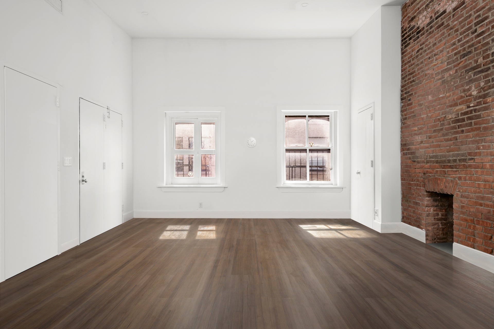 99 Spring Street, Unit PH Manhattan, NY 10012 - Photo 7 of 23 a view of an empty room with wooden floor and a window