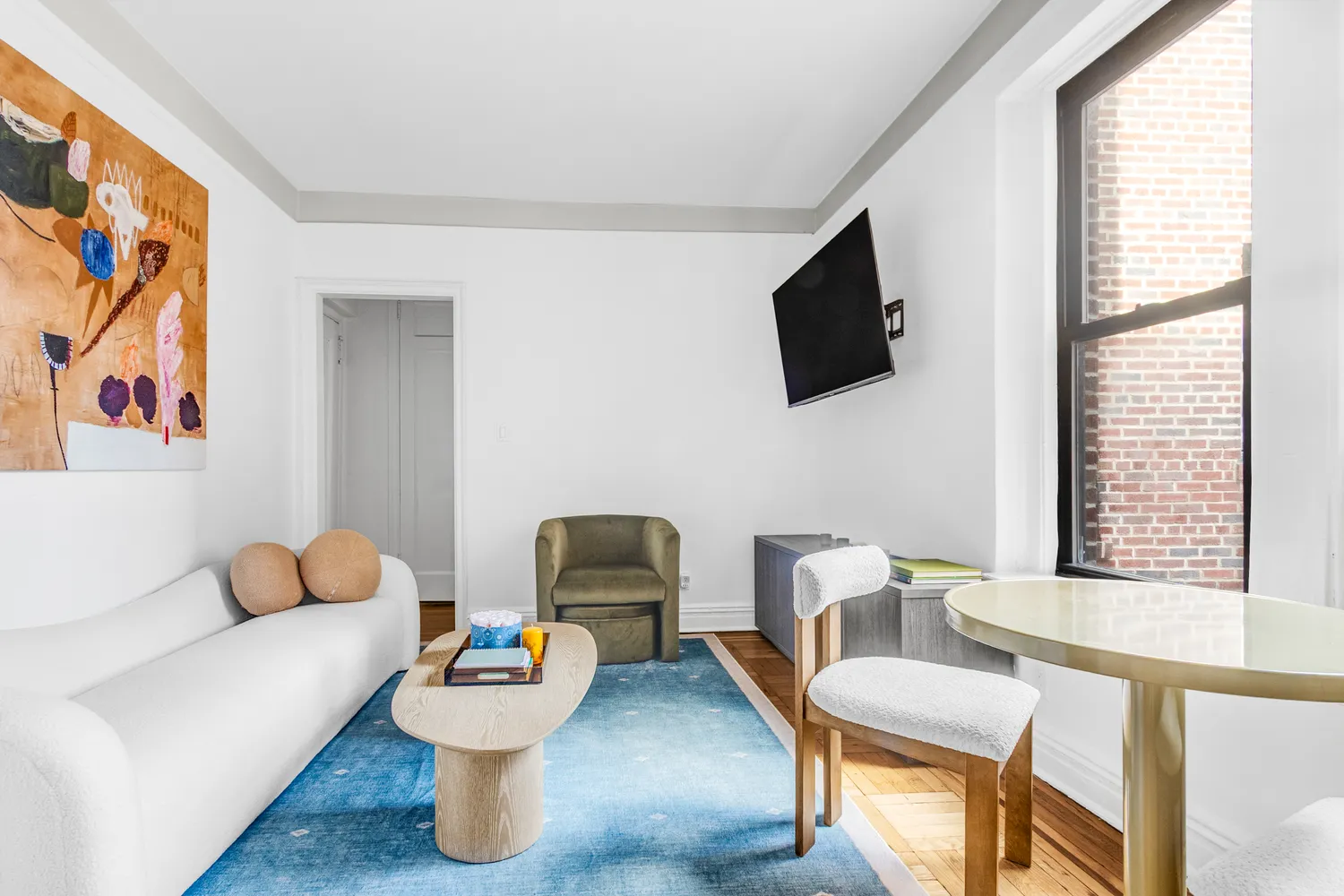 a living room with furniture and a flat screen tv