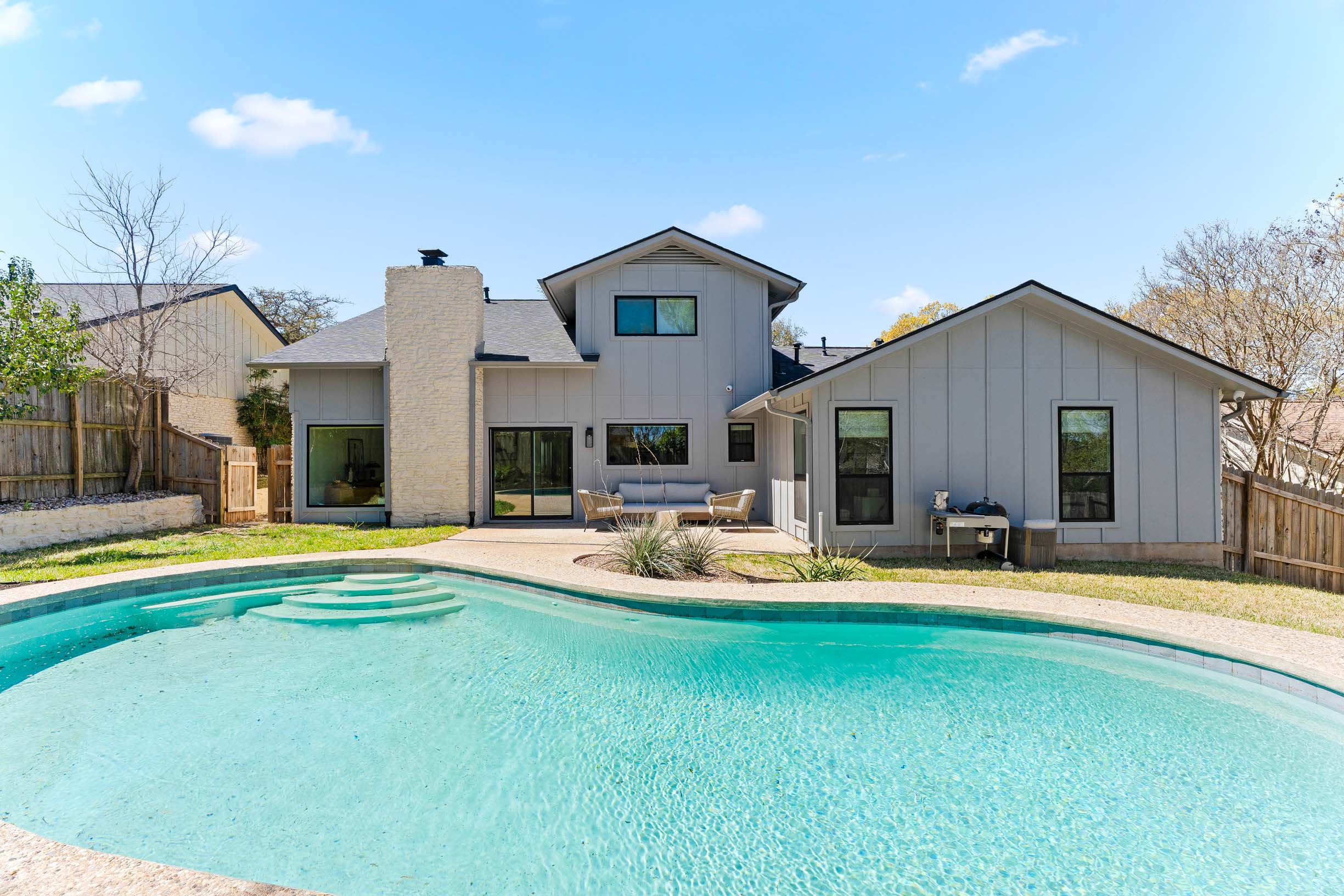 1317 Thaddeus Cove Austin, TX 78746 - Photo 19 of 22 a view of a house with swimming pool and a yard