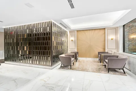 a living room with a large window and chairs