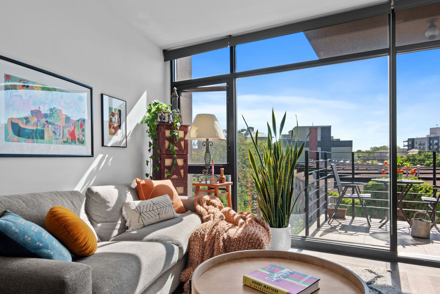 179 Woodpoint Road, Unit 4A Brooklyn, NY 11211 - Photo 5 of 16 a living room with furniture a floor to ceiling window and potted plants