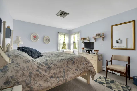 a bedroom with a bed and a couch
