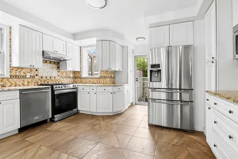 a kitchen with stainless steel appliances a refrigerator sink and cabinets