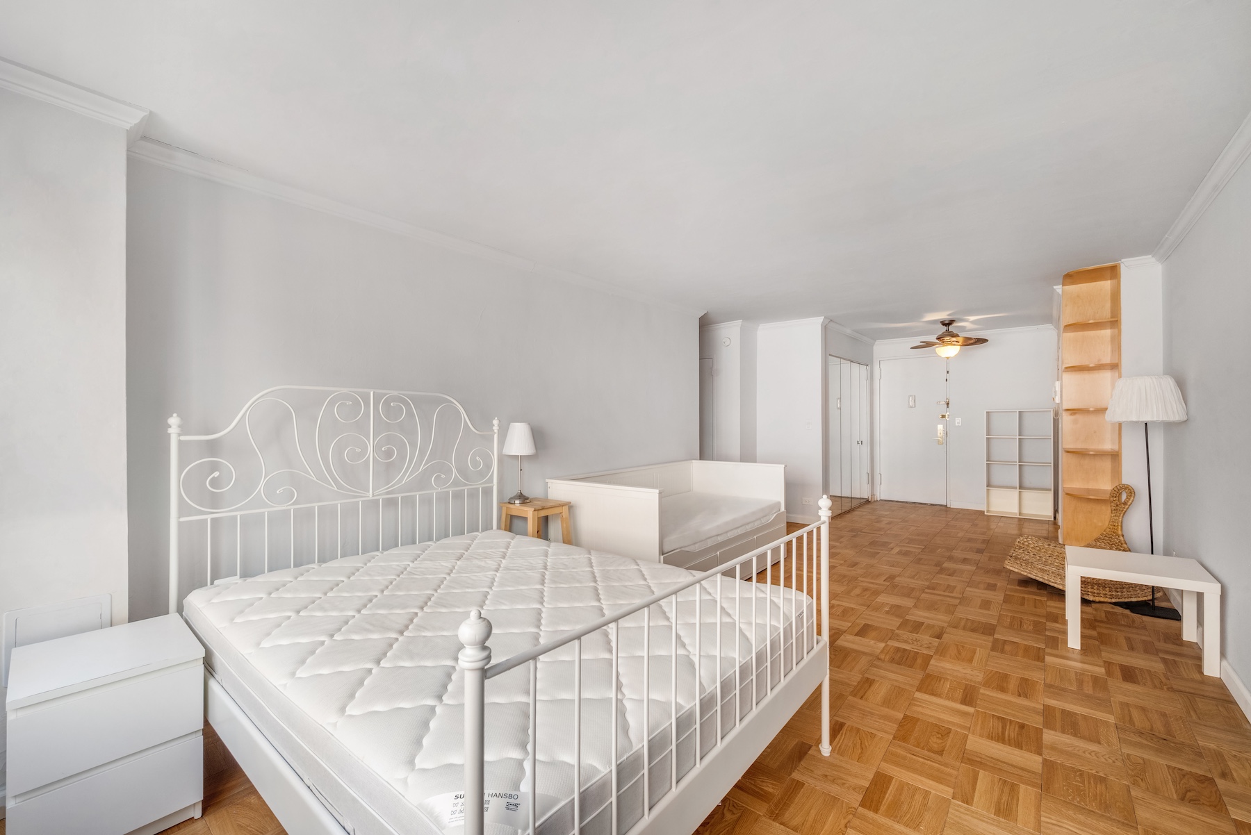 301 East 64th Street, Unit 4J Manhattan, NY 10065 - Photo 2 of 5 a bedroom with a bed and a table