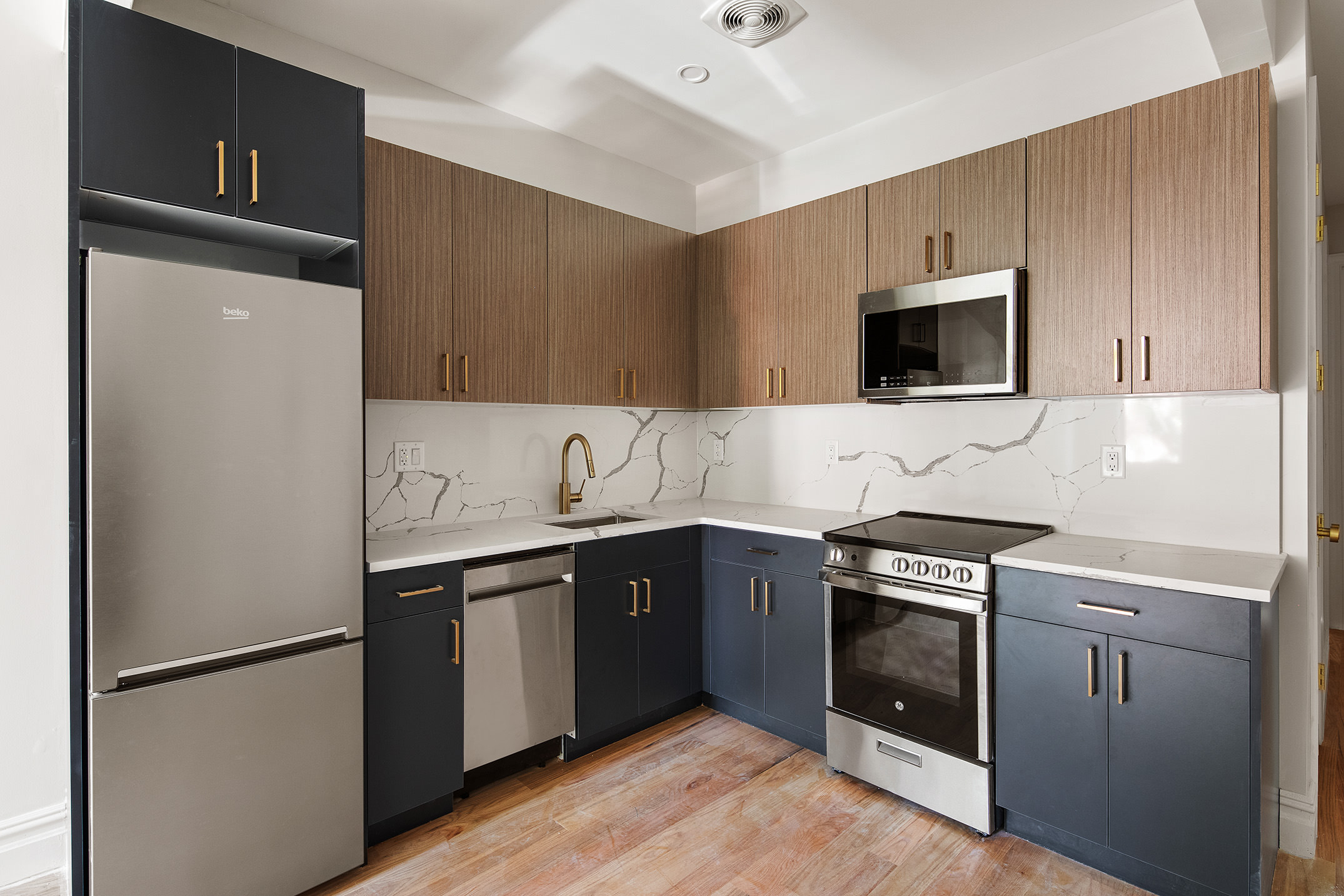 1110 Putnam Avenue, Unit 2 Brooklyn, NY 11221 - Photo 3 of 8 a kitchen with stainless steel appliances a stove microwave and refrigerator