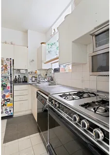 a kitchen with stainless steel appliances granite countertop a stove and a microwave