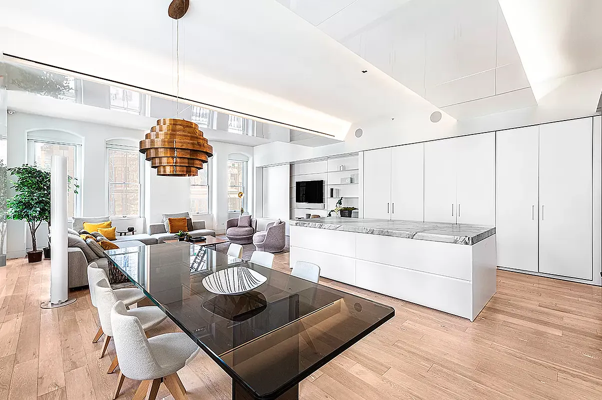 186 5th Avenue, Unit 4A Manhattan, NY 10010 - Photo 3 of 12 a living room with stainless steel appliances kitchen island granite countertop furniture a rug kitchen view and a chandelier
