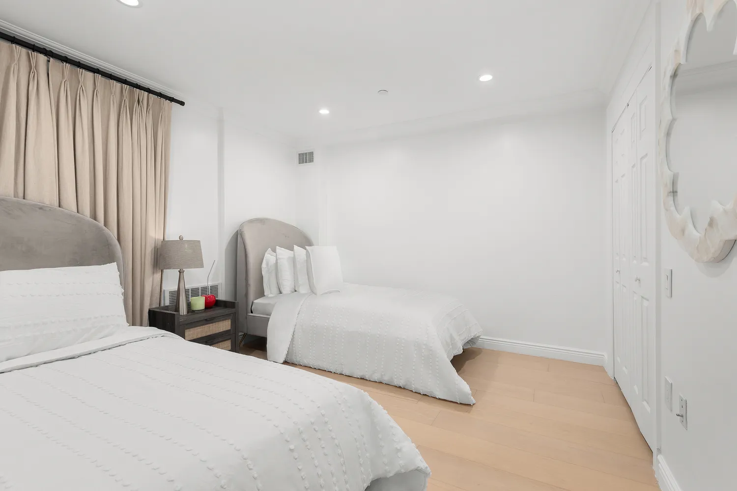 a bedroom with two beds and a window