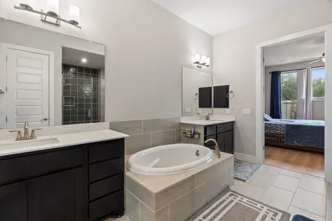 a bathroom with a glass shower door and a window