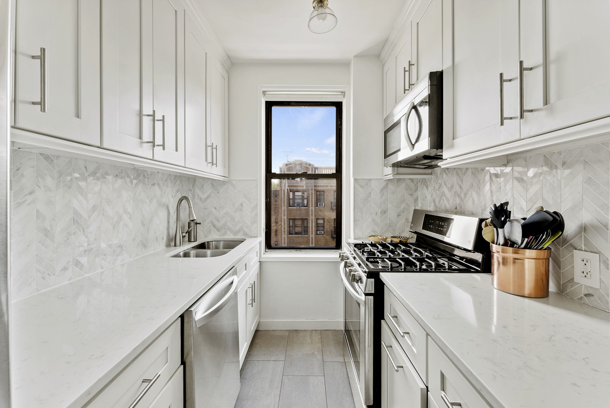 675 Academy Street, Unit 5E Manhattan, NY 10034 - Photo 5 of 10 a kitchen with a stove and a refrigerator