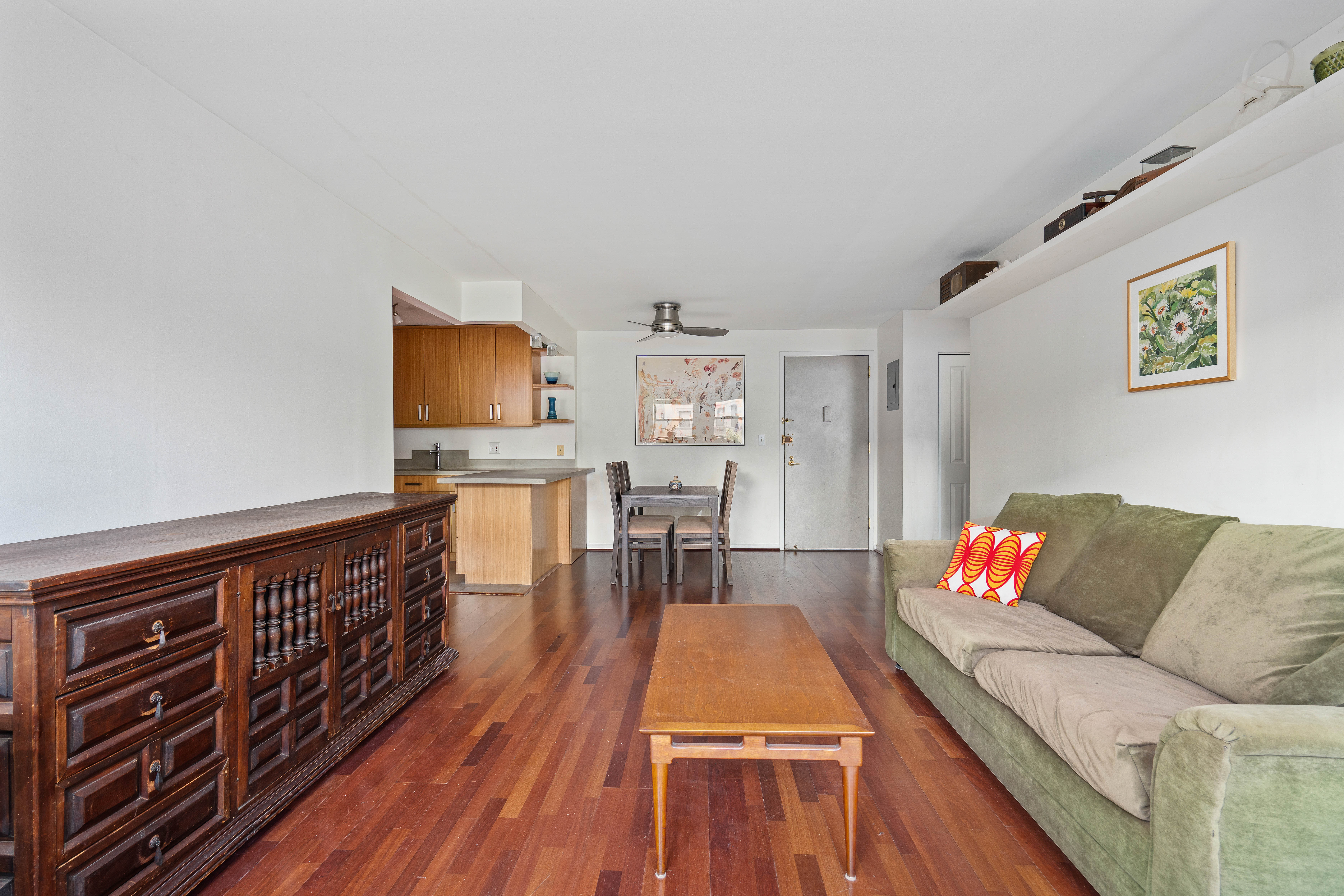 130 Lenox Avenue, Unit 522 Manhattan, NY 10026 - Photo 3 of 7 a living room with furniture and a wooden floor