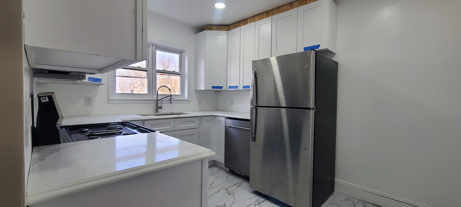 97-08 Plattwood Avenue, Unit 2 Queens, NY 11417 - Photo 2 of 10 a kitchen with a refrigerator and a sink