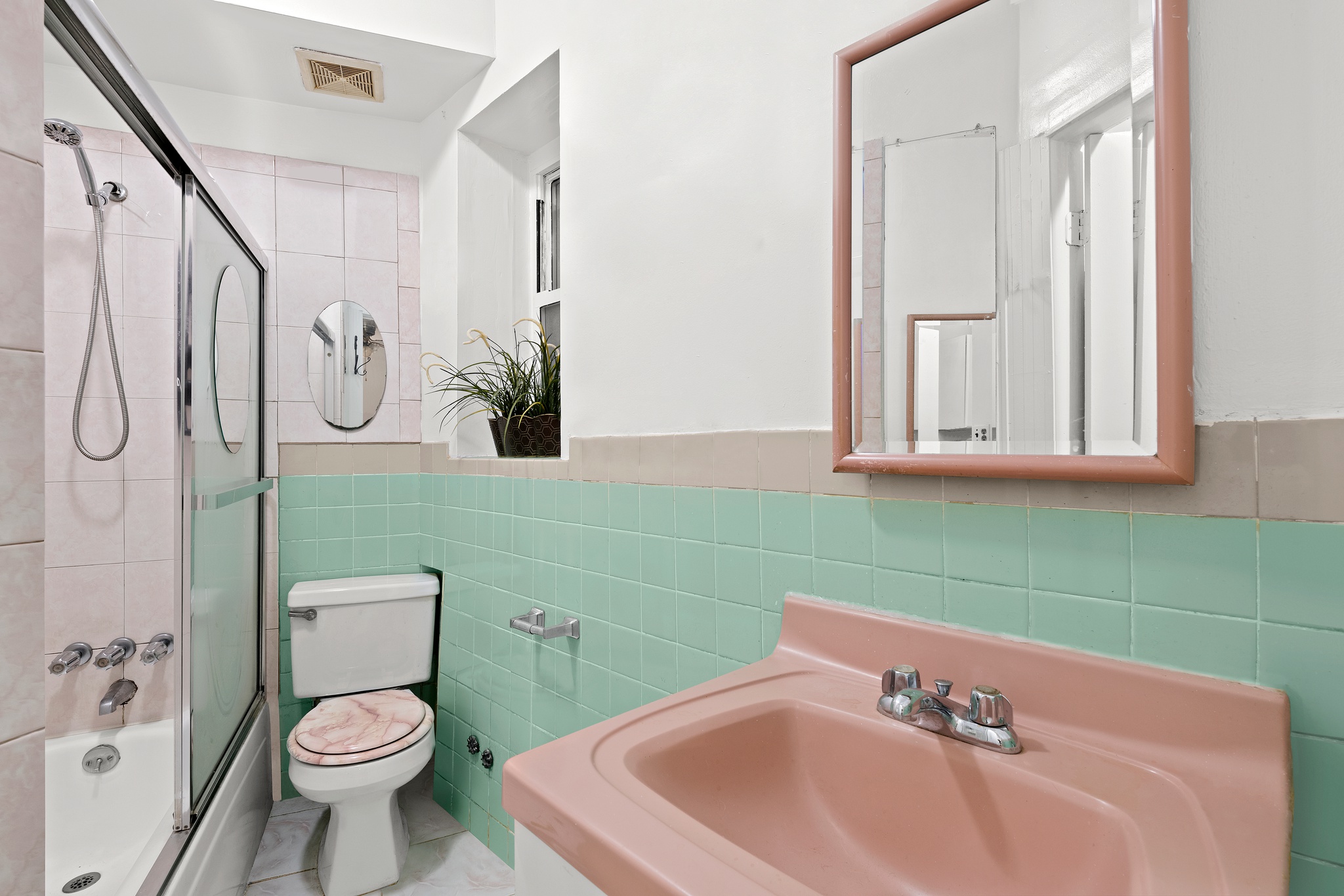 715 9th Avenue, Unit 2FN Manhattan, NY 10019 - Photo 10 of 11 a bathroom with a sink a toilet and a mirror