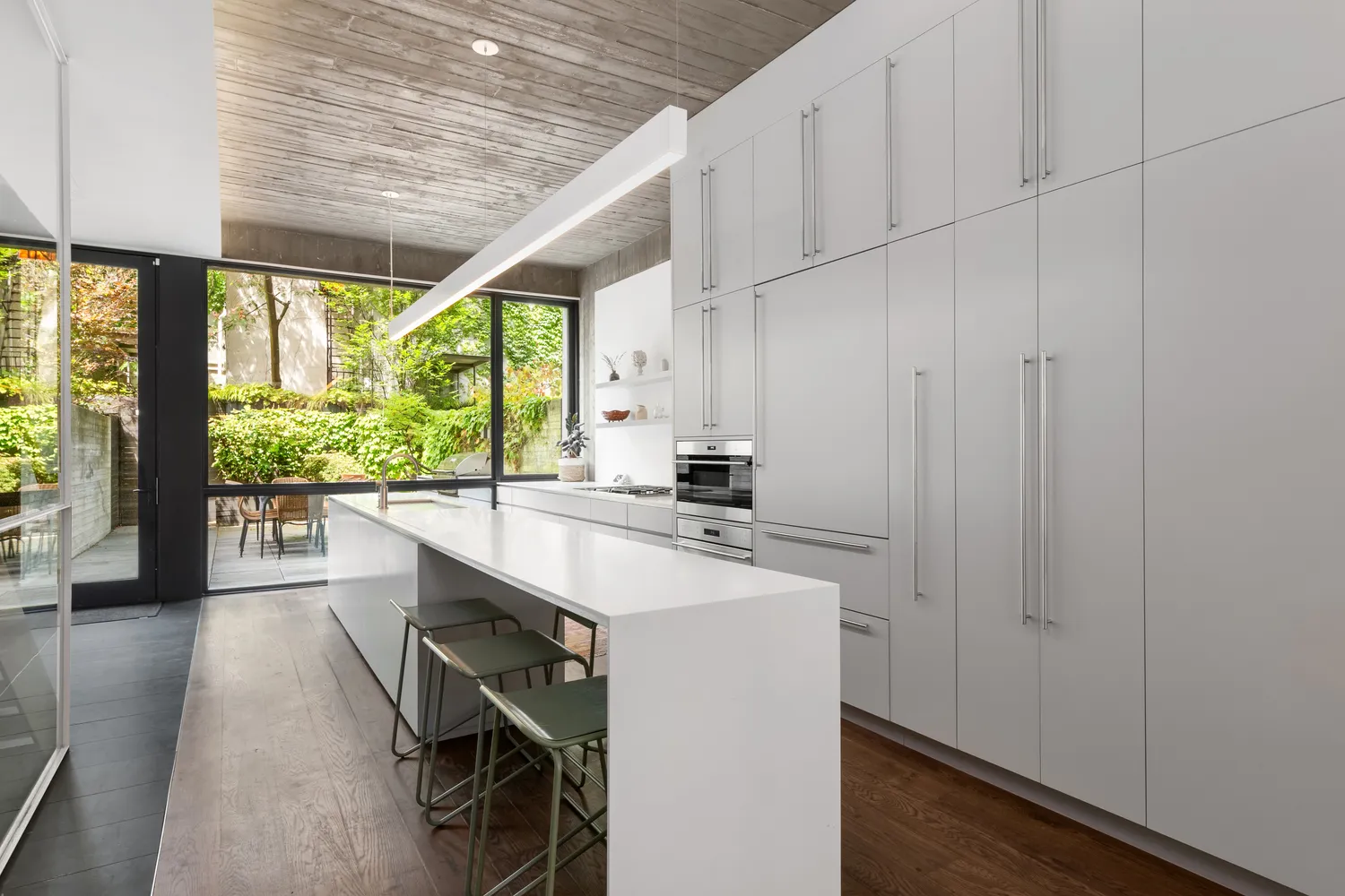 a kitchen with a sink and wooden floor