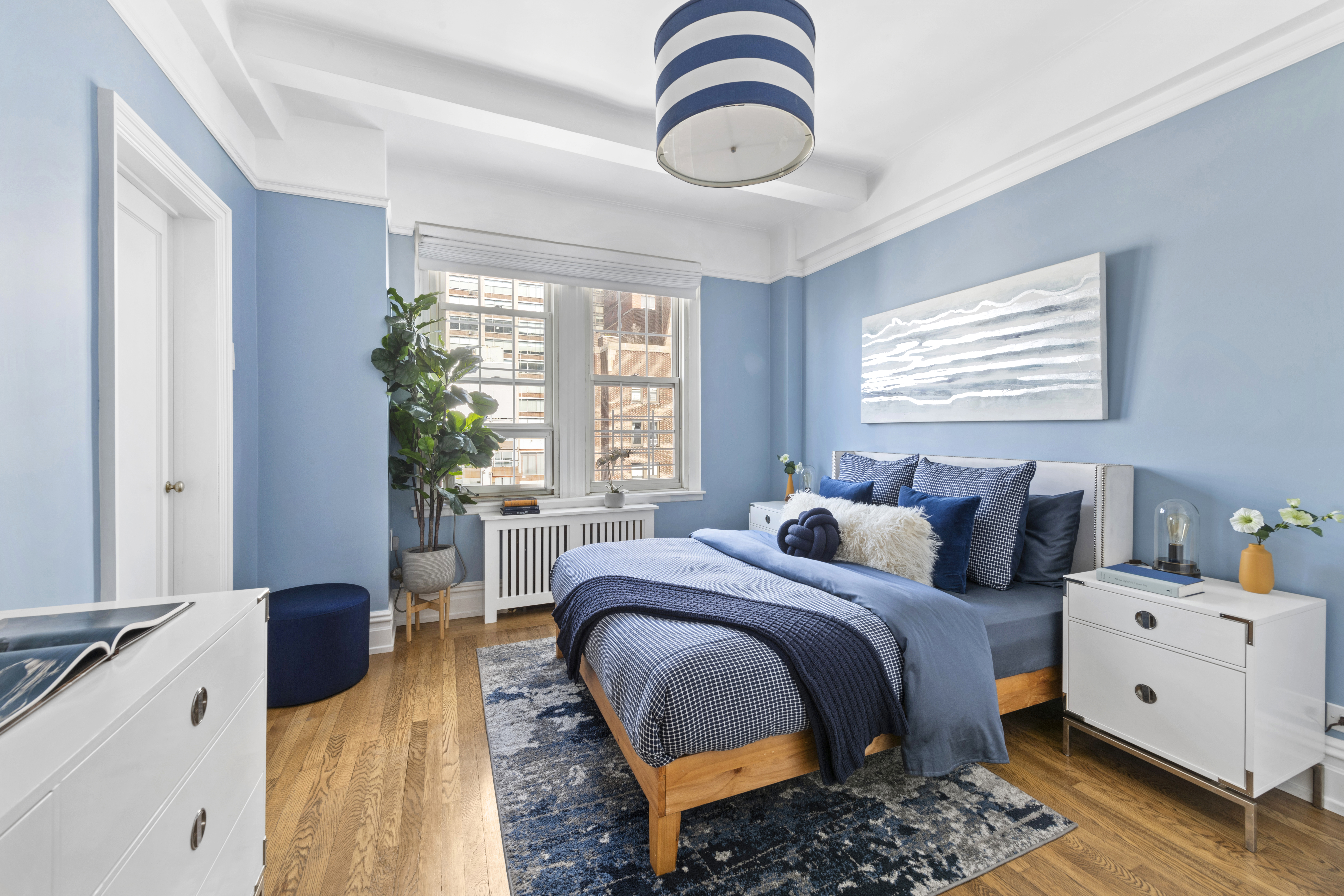 410 East 57th Street, Unit 15BE Manhattan, NY 10022 - Photo 13 of 18 a bedroom with a bed and a chandelier
