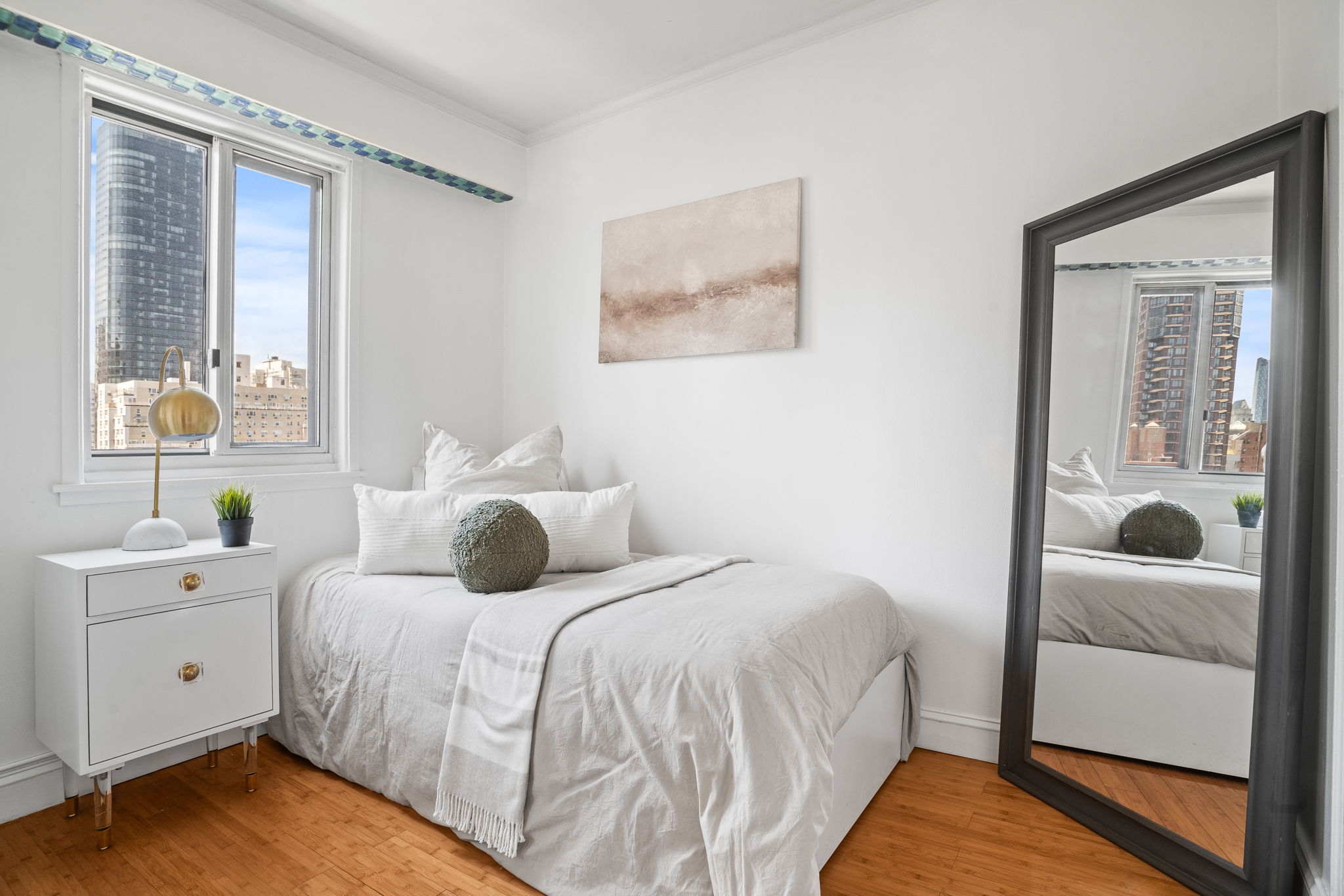 401 East 65th Street, Unit 12F Manhattan, NY 10065 - Photo 8 of 18 a bedroom with a large bed and a window
