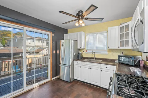 a kitchen with stainless steel appliances a sink a stove and a refrigerator