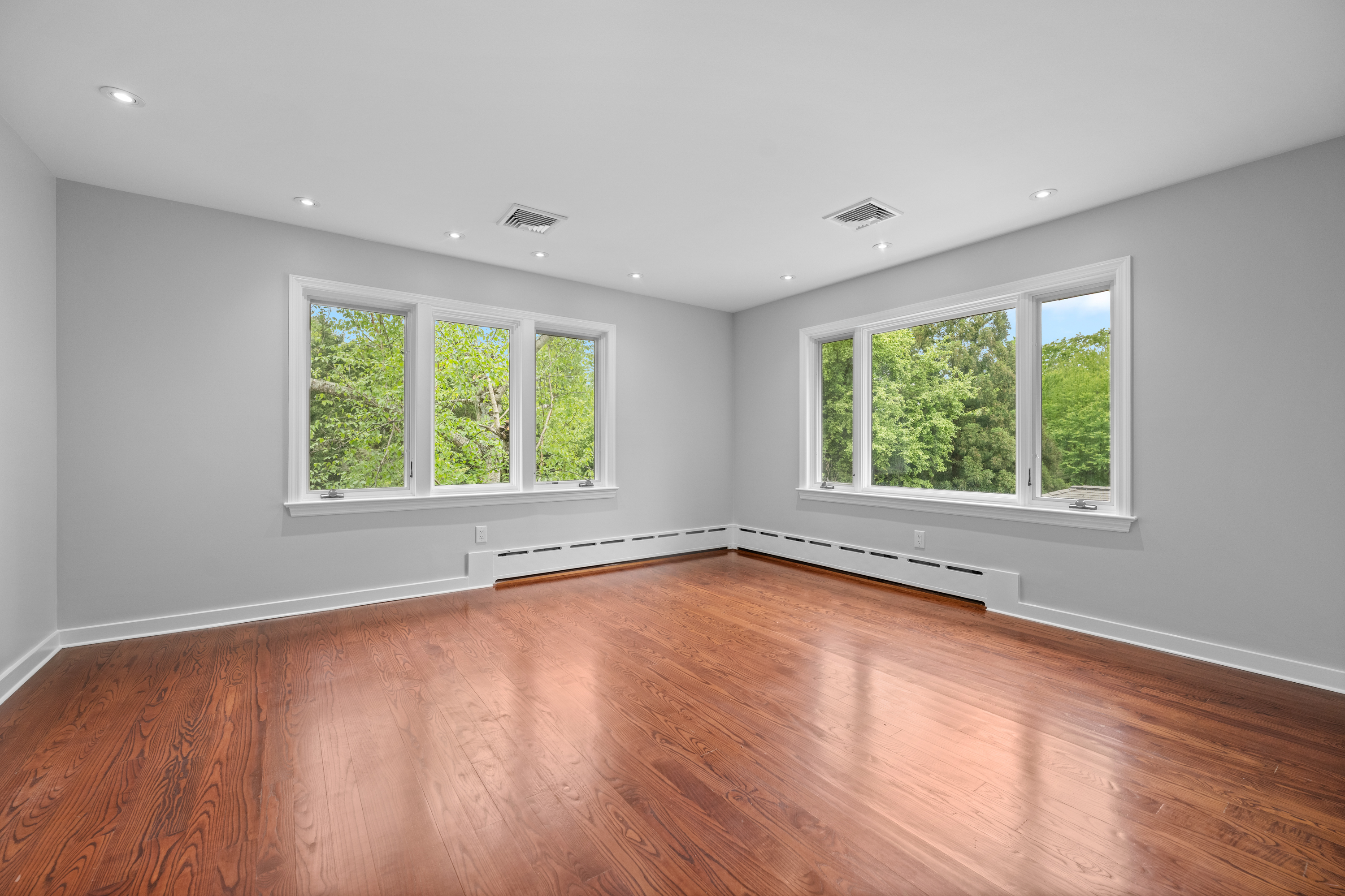 850 Lesley Road Villanova, PA 19085 - Photo 31 of 45 an empty room with wooden floor and windows