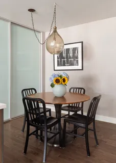 a dining room with furniture and wooden floor
