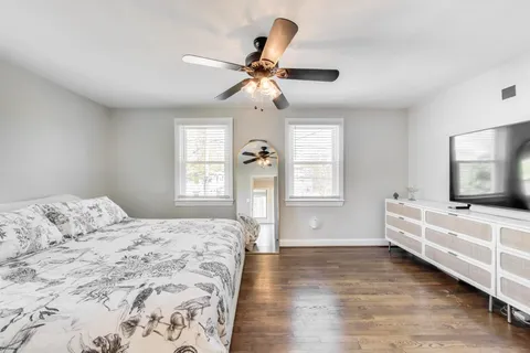 a bedroom with a bed and a chandelier