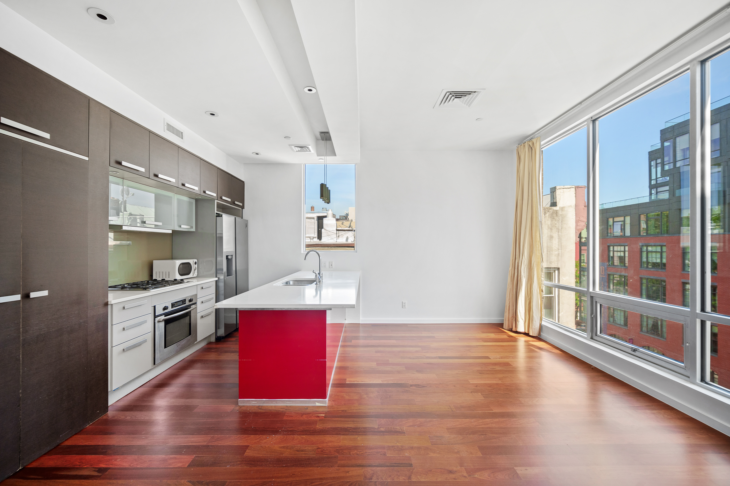170 North 11th Street, Unit 5B Brooklyn, NY 11211 - Photo 4 of 11 a kitchen with stainless steel appliances granite countertop a refrigerator a stove top oven and a wooden floors