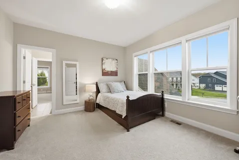 a spacious bedroom with a bed and a ceiling fan